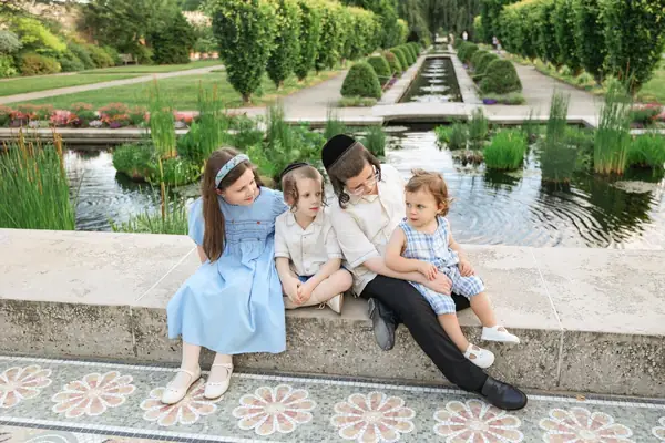 Mother and four children on a garden wall, outdoor family photography by Photoholic, Rockland County NY
