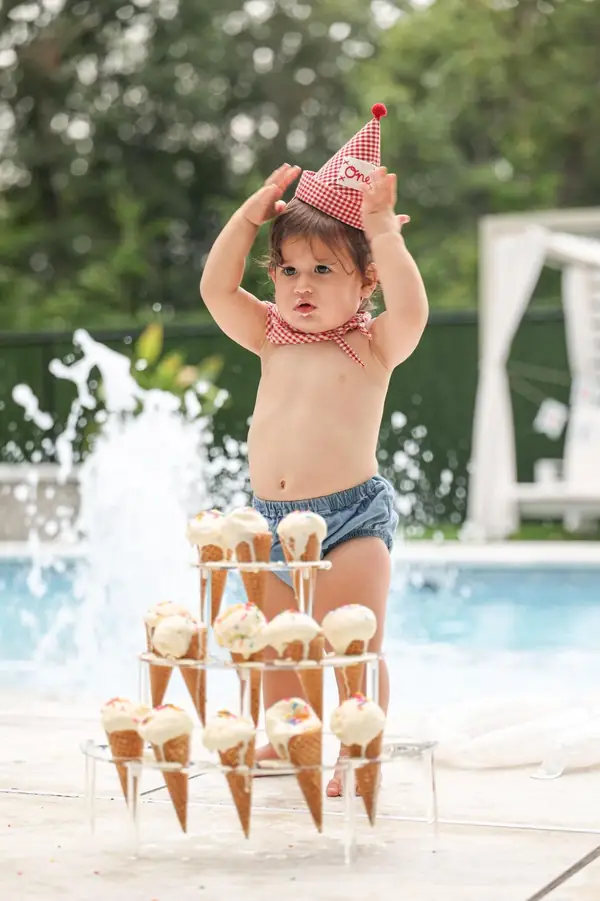 Toddler with an ice cream cone tower by a pool fountain, outdoor family photography by Photoholic, Rockland County NY